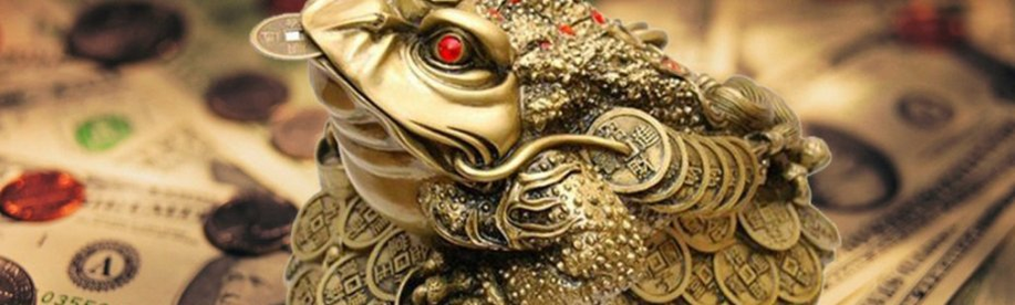 Un crapaud avec une pièce dans la bouche - un talisman qui attire de l'argent